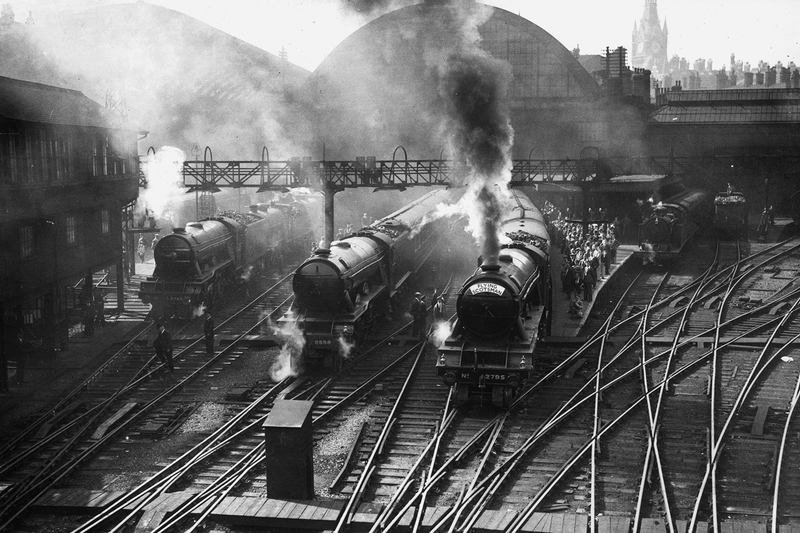 4th August 1934: At King’s Cross, London, Pacific type locomotives No 2795 Call Boy (after winner of 1927 Derby) of Haymarket shed is pulling the Flying Scotsman. On the left of it is No 2598 Blenheim (after winner of 1930 Derby) pulling the Junior Scotsman. There is a good example of a four-way point in the foreground. (Photo by Hudson/Topical Press Agency/Getty Images)